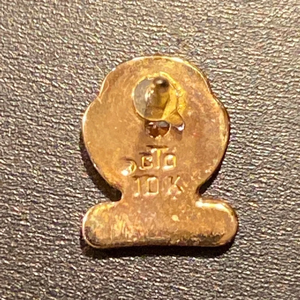 Set of 2 gold pins for city services one marked 14k on 10k one with a diamond